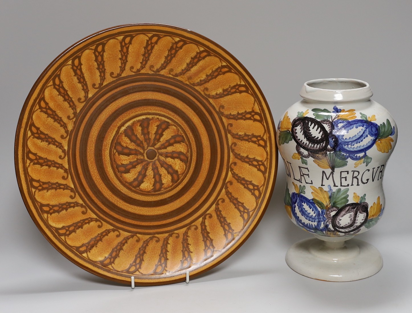 A large Doulton wall plate, model no. D6061 - 34cm diameter and a Dutch Delft drug jar - 26cm tall